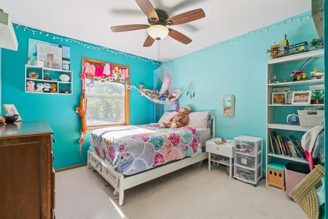 a bedroom with a bed and a bookshelf
