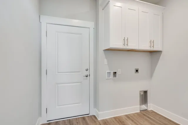 a view of storage and utility room with wooden floor