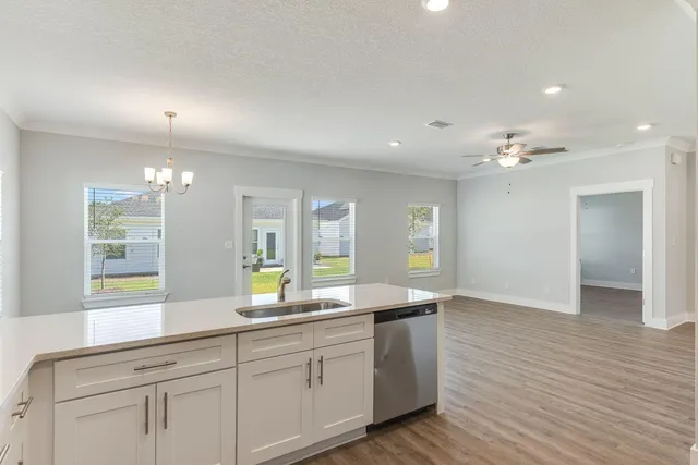 a spacious bathroom with double vanity and a mirror