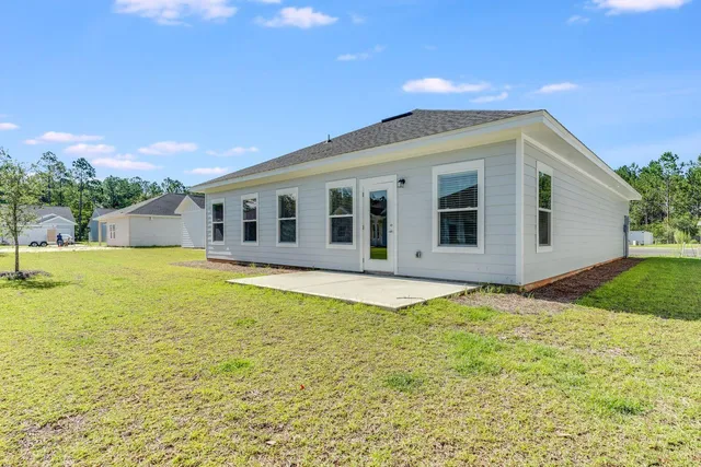 a view of a house with swimming pool and a yard