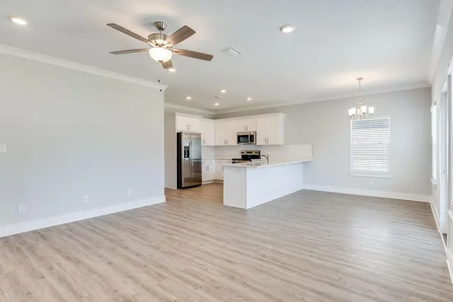 a view of kitchen with kitchen island wooden floor center island and appliances