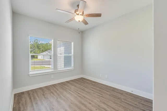 wooden floor in an empty room with a window