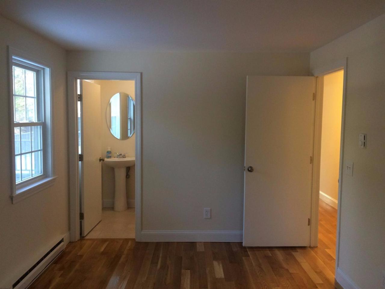 48 North Precinct Road Centerville, MA 02632 - Photo 19 of 28 an empty room with wooden floor and windows