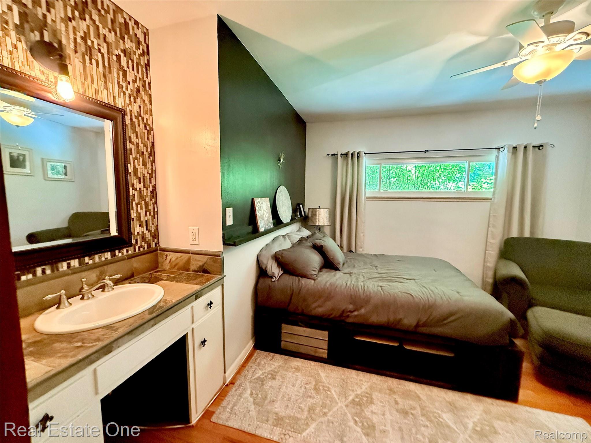 2189 Devonshire Road Bloomfield Hills, MI 48302 - Photo 21 of 50 Integrated vanity with a vessel sink, mosaic tile backsplash, and a framed mirror
