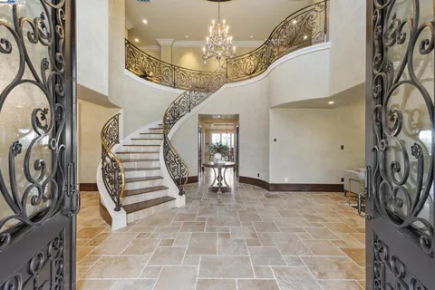 a view of a dining room with furniture and chandelier