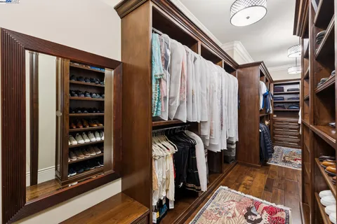a bathroom with a granite countertop sink a mirror and a shower