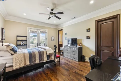 a living room with furniture a chandelier and a large window