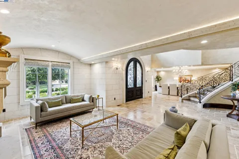 a kitchen with granite countertop a sink a center island and appliances