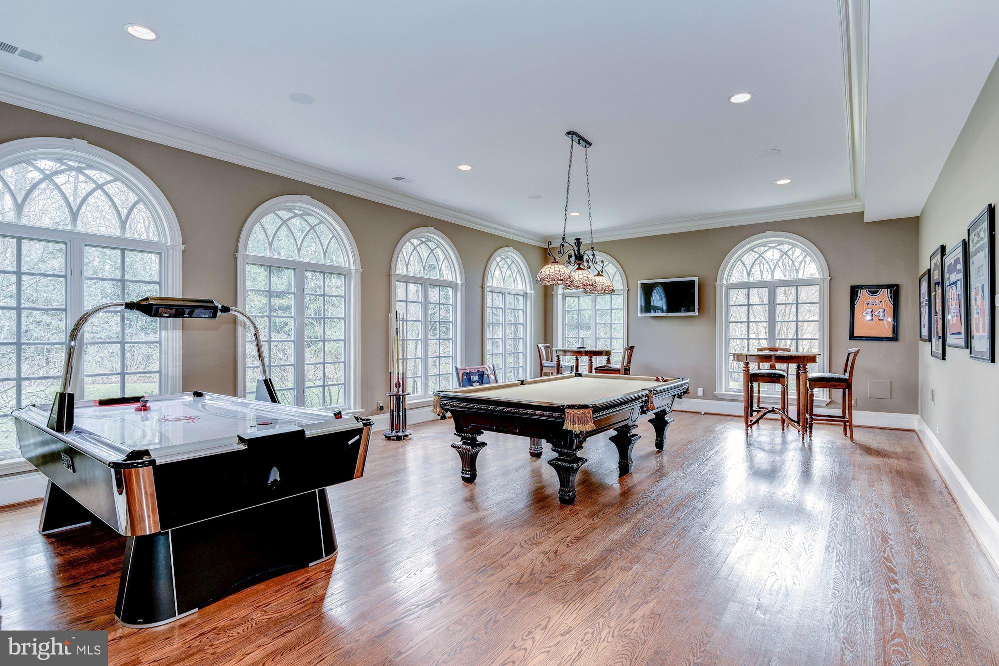 7712 Georgetown Pike McLean, VA 22102 - Photo 23 of 35 a living room with fireplace furniture and a wooden floor