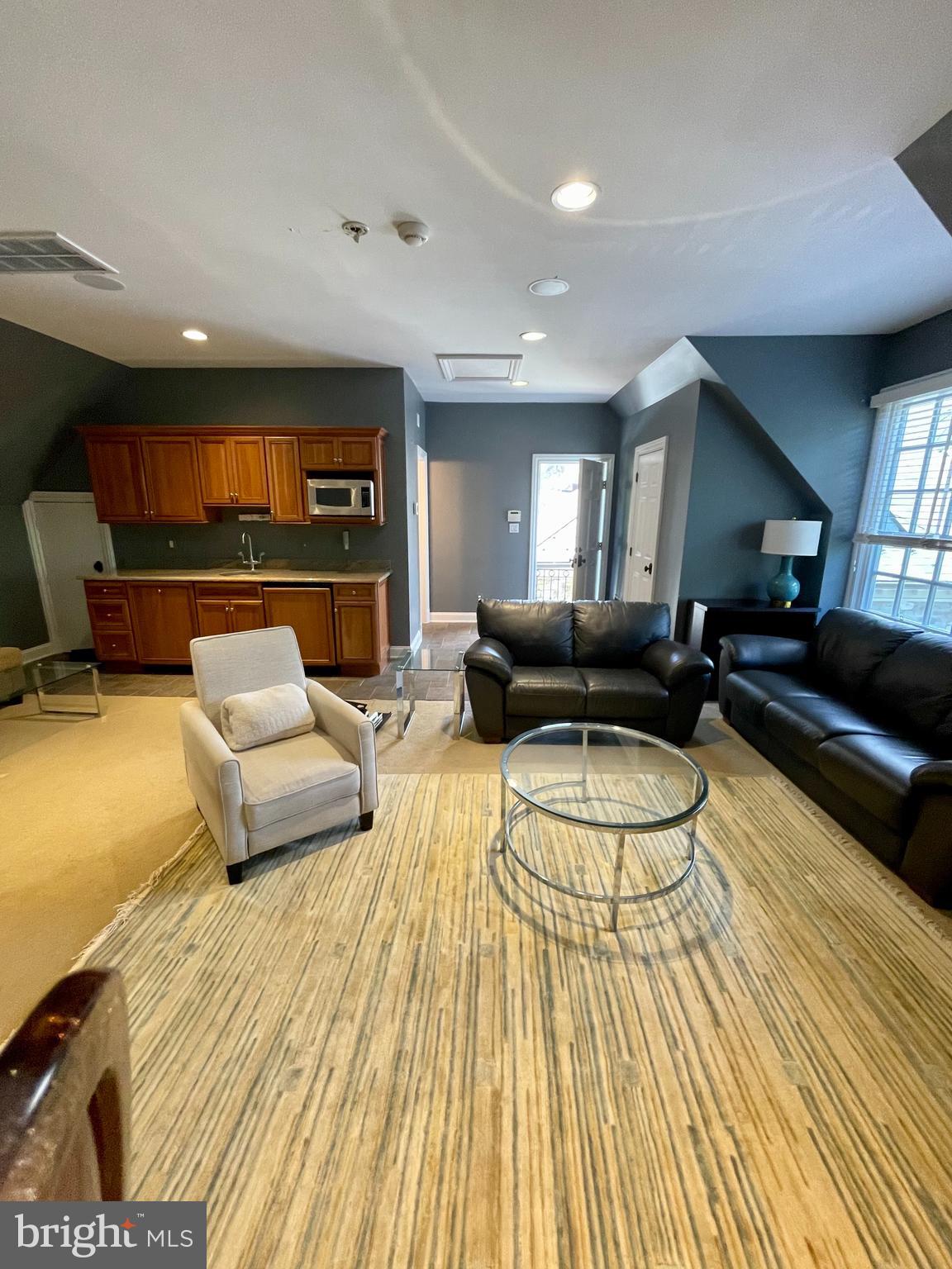 7712 Georgetown Pike McLean, VA 22102 - Photo 30 of 35 a living room with furniture and a wooden floor