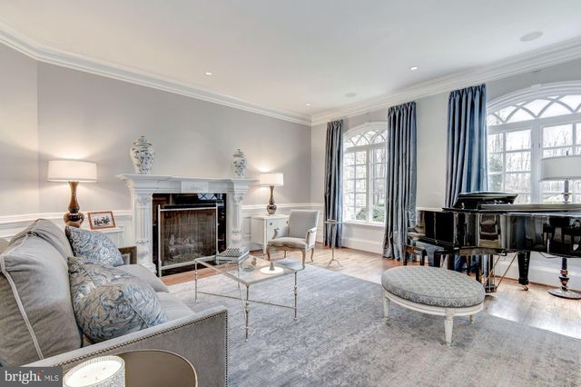 a living room with furniture a large window and a fireplace