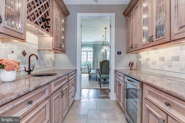 a kitchen with granite countertop a sink and cabinets