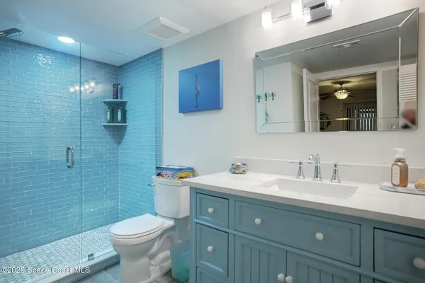 a bathroom with a double vanity sink toilet and shower