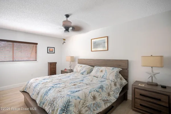 a bedroom with a bed and a lamp