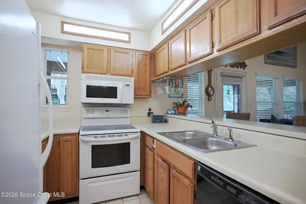 a kitchen with stainless steel appliances granite countertop a sink and a stove