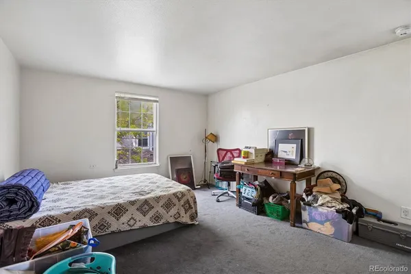 a bedroom with a bed and a desk