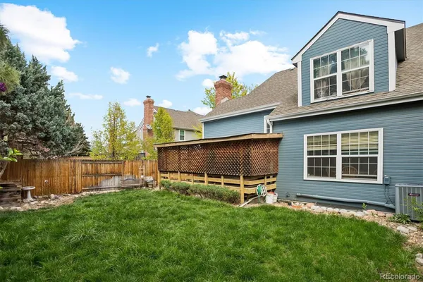 a backyard of a house with barbeque oven and outdoor seating