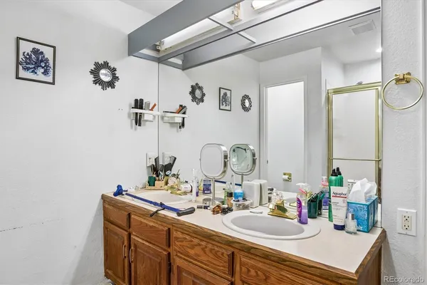 a bathroom with a sink vanity and mirror