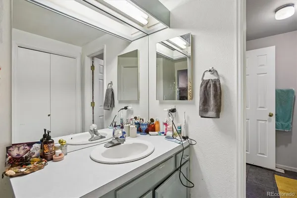 a bathroom with a sink vanity and a mirror