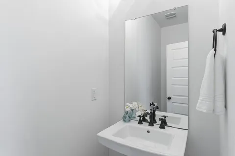 a open kitchen with stainless steel appliances granite countertop a stove a sink a dining table and chairs with wooden floor