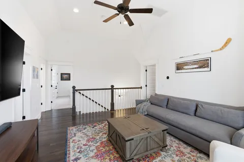 a living room with furniture flat screen tv and window