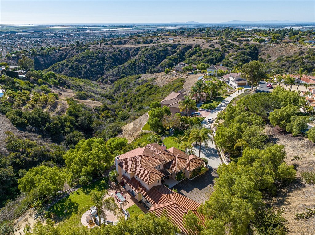 an aerial view of a house with a yard