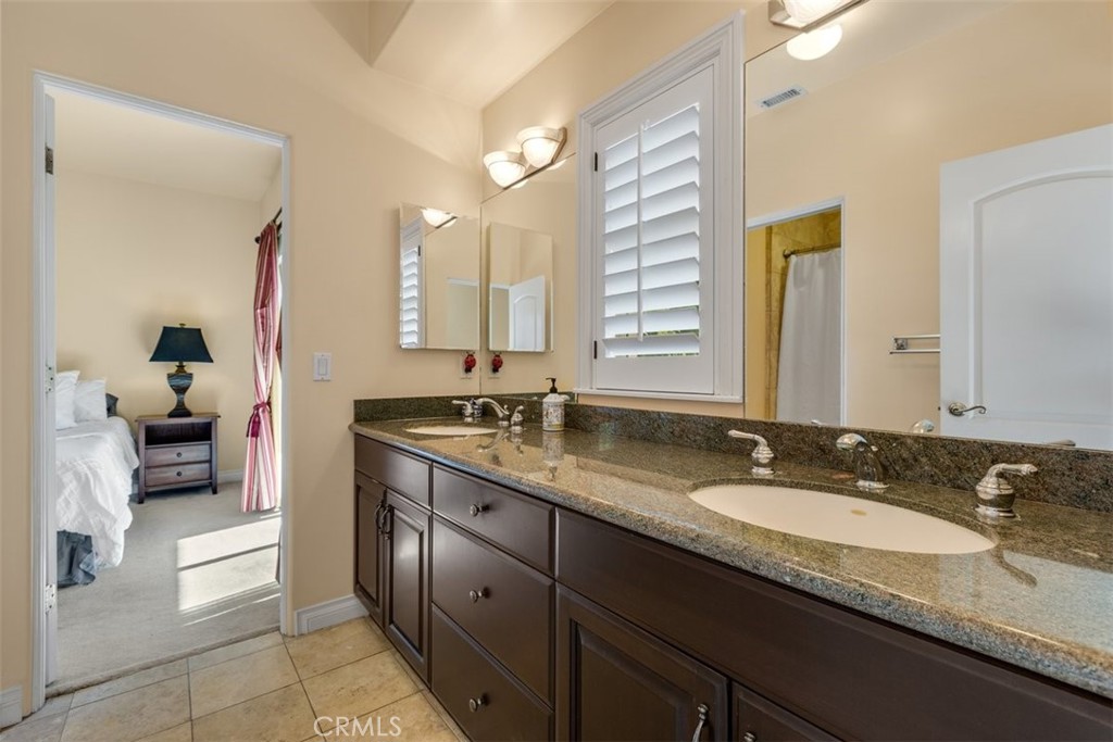 77 Altamont Way Camarillo, CA 93010 - Photo 19 of 48 a bathroom with a granite countertop sink and a mirror