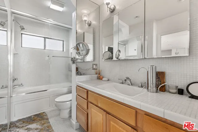 a view of a patio with table and chairs potted plants