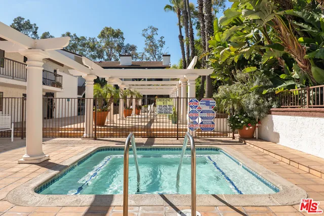 a view of house with swimming pool outdoor seating