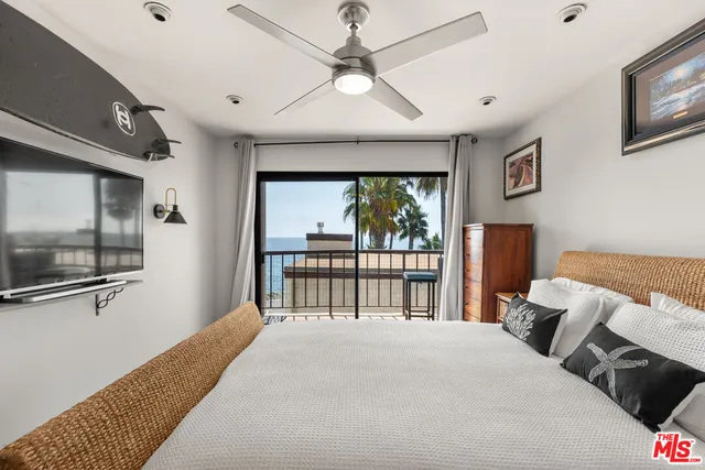 a bedroom with a large bed and a tv