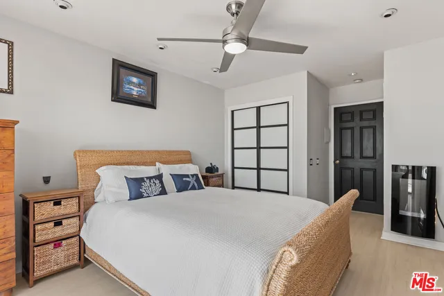 a bedroom with a large bed and a chandelier