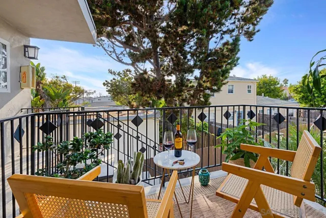 a view of a chairs and table in the balcony