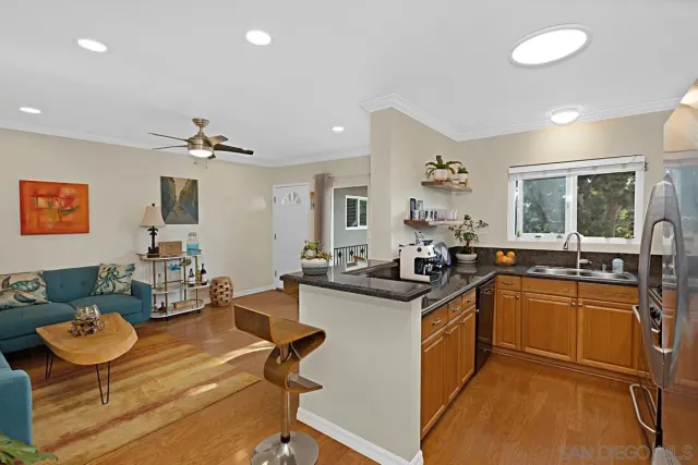 a kitchen with granite countertop a refrigerator and a stove top oven