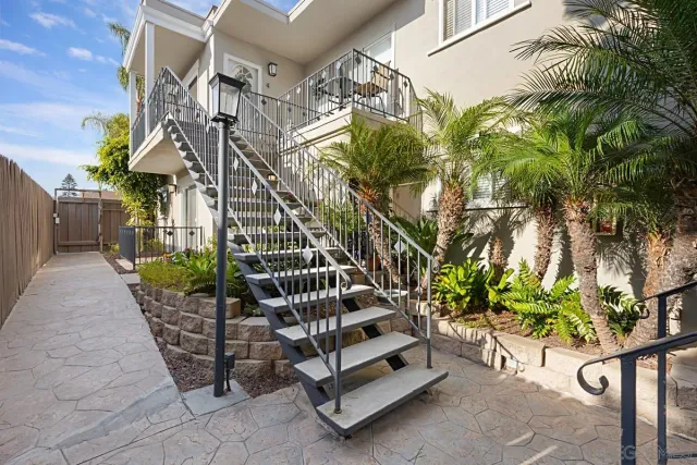 a view of a pathway of a house with flower plants