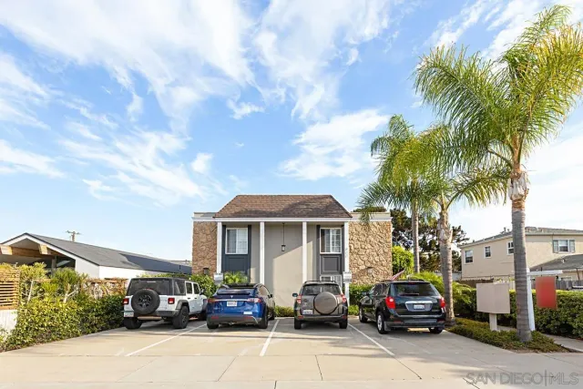 a front view of a house with plants