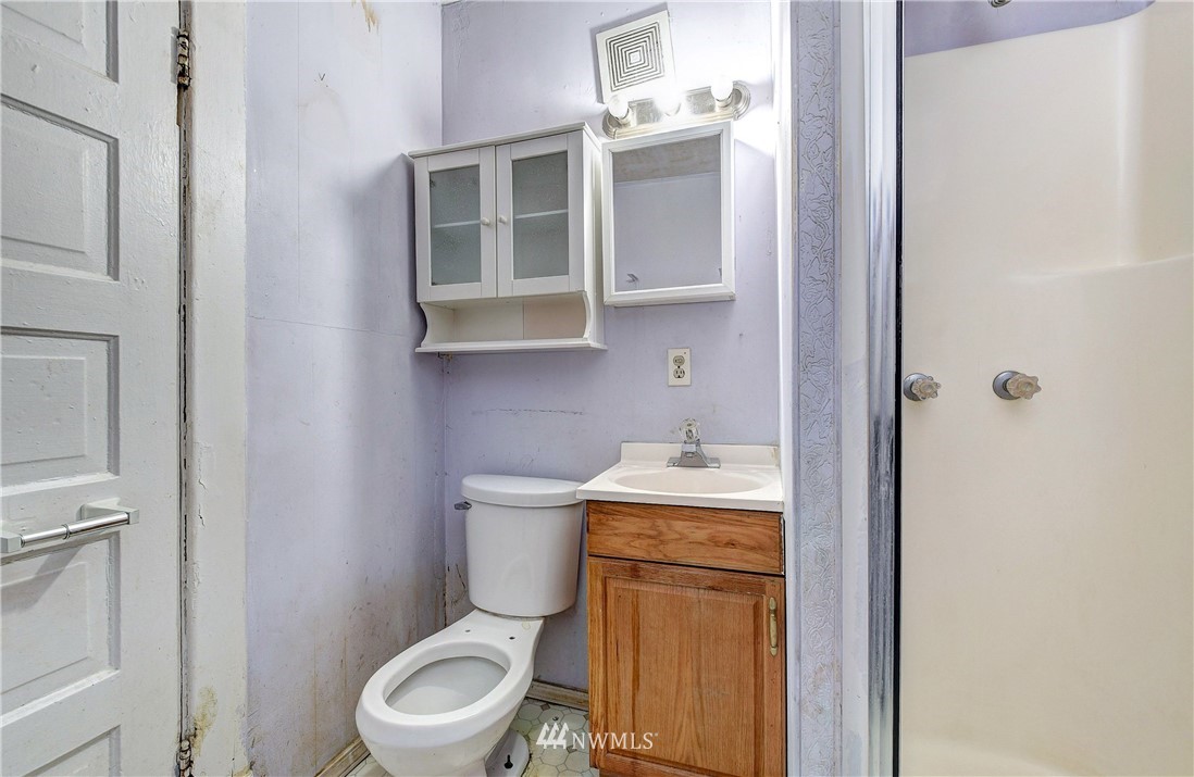 3618 Rucker Avenue Everett, WA 98201 - Photo 15 of 33 a white toilet sitting next to a bathroom sink