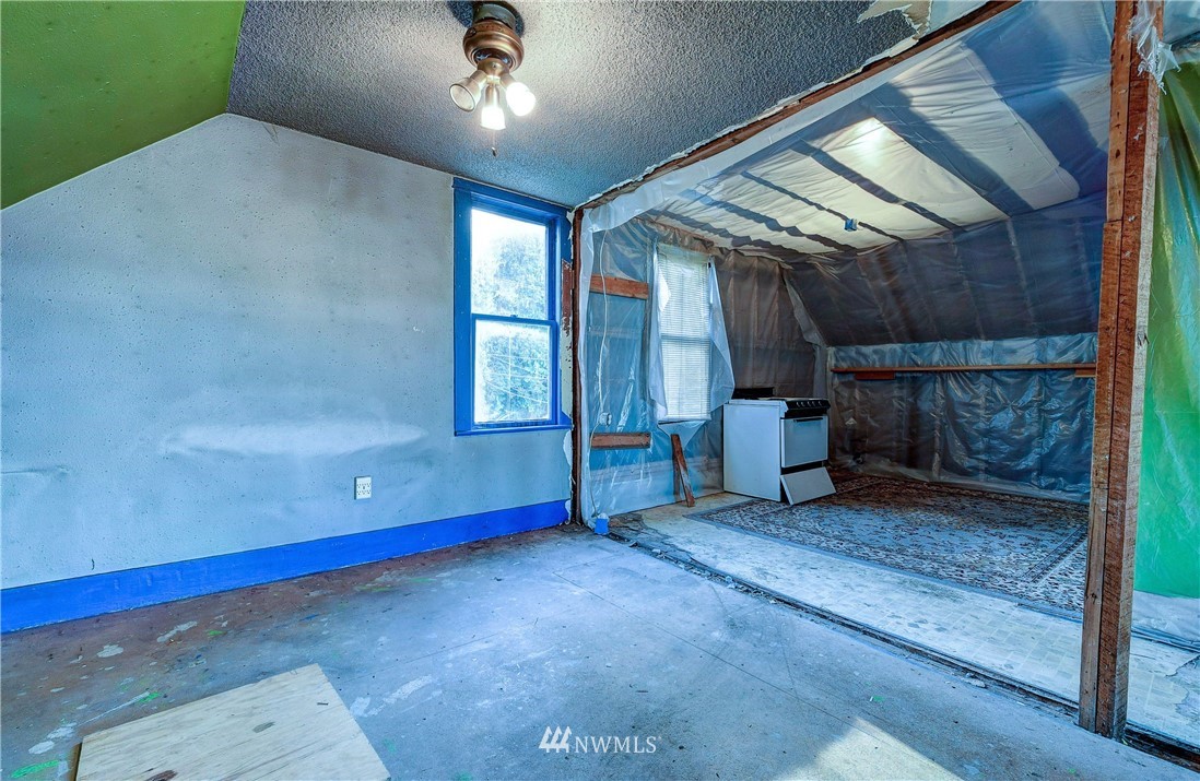 3618 Rucker Avenue Everett, WA 98201 - Photo 18 of 33 a view of an empty room with a fireplace and a ceiling fan