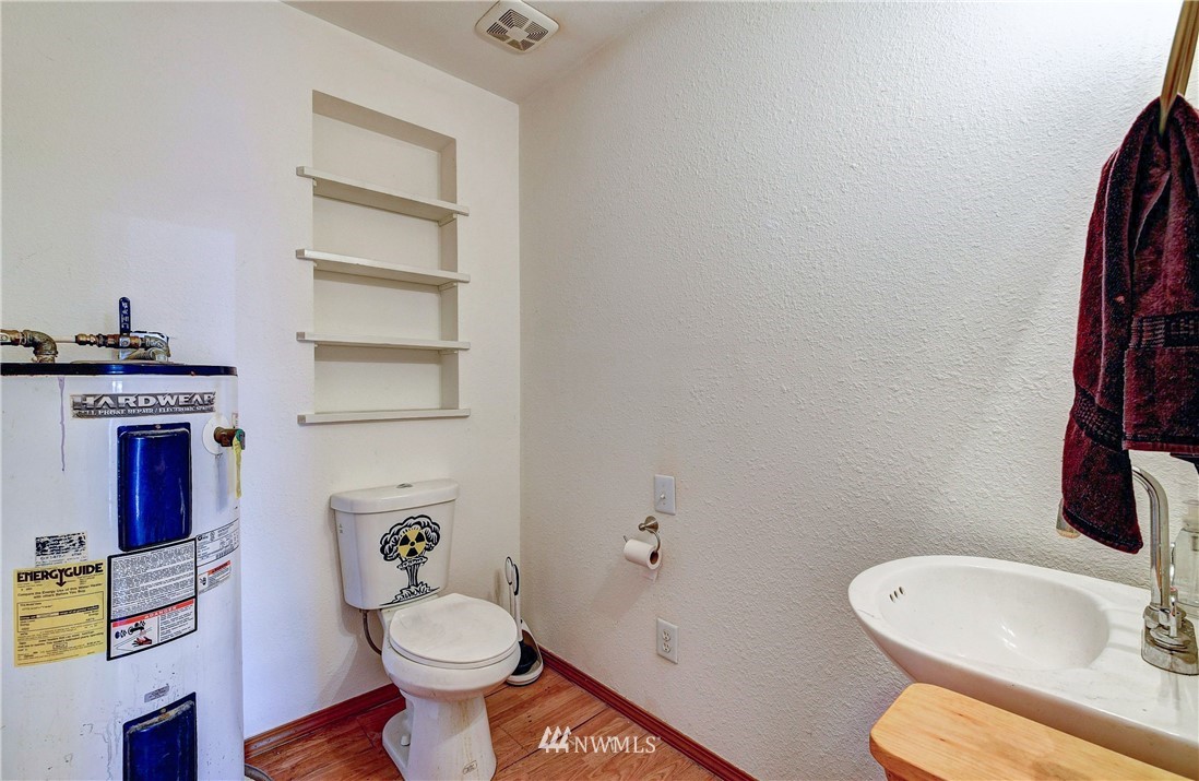 3618 Rucker Avenue Everett, WA 98201 - Photo 28 of 33 a white toilet sitting next to a bathroom sink and vanity