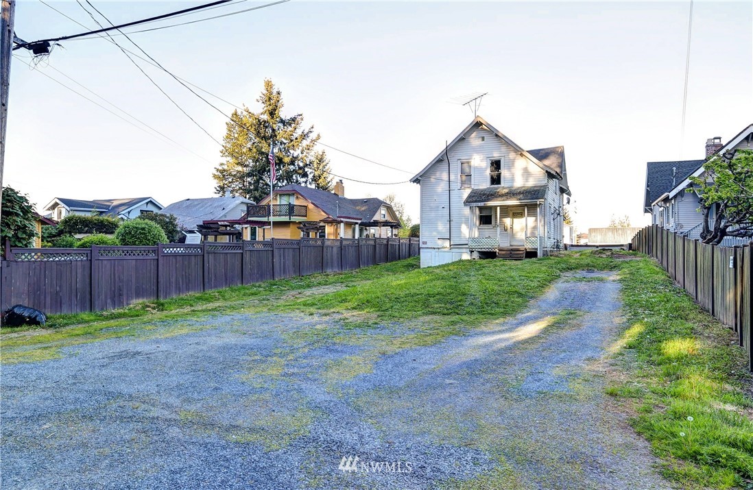 3618 Rucker Avenue Everett, WA 98201 - Photo 6 of 33 a front view of a house with backyard and wooden fence
