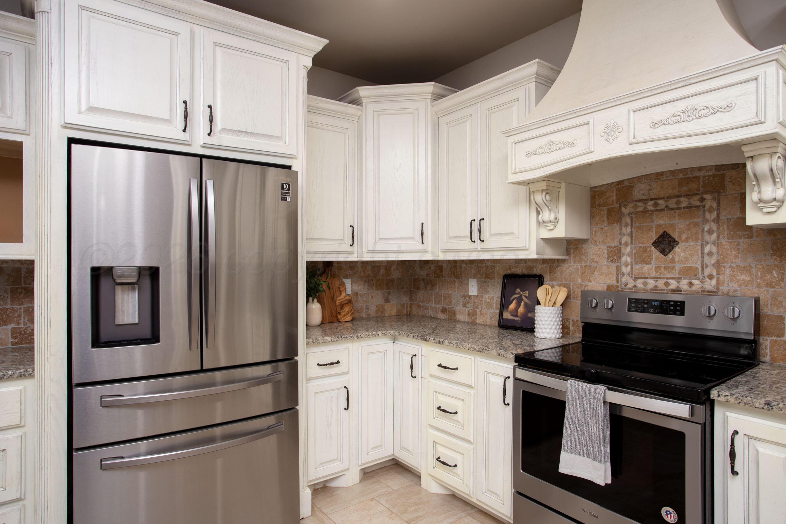 9551 Yesterday Lane Amarillo, TX 79119 - Photo 15 of 53 a kitchen with stainless steel appliances granite countertop a refrigerator sink and stove