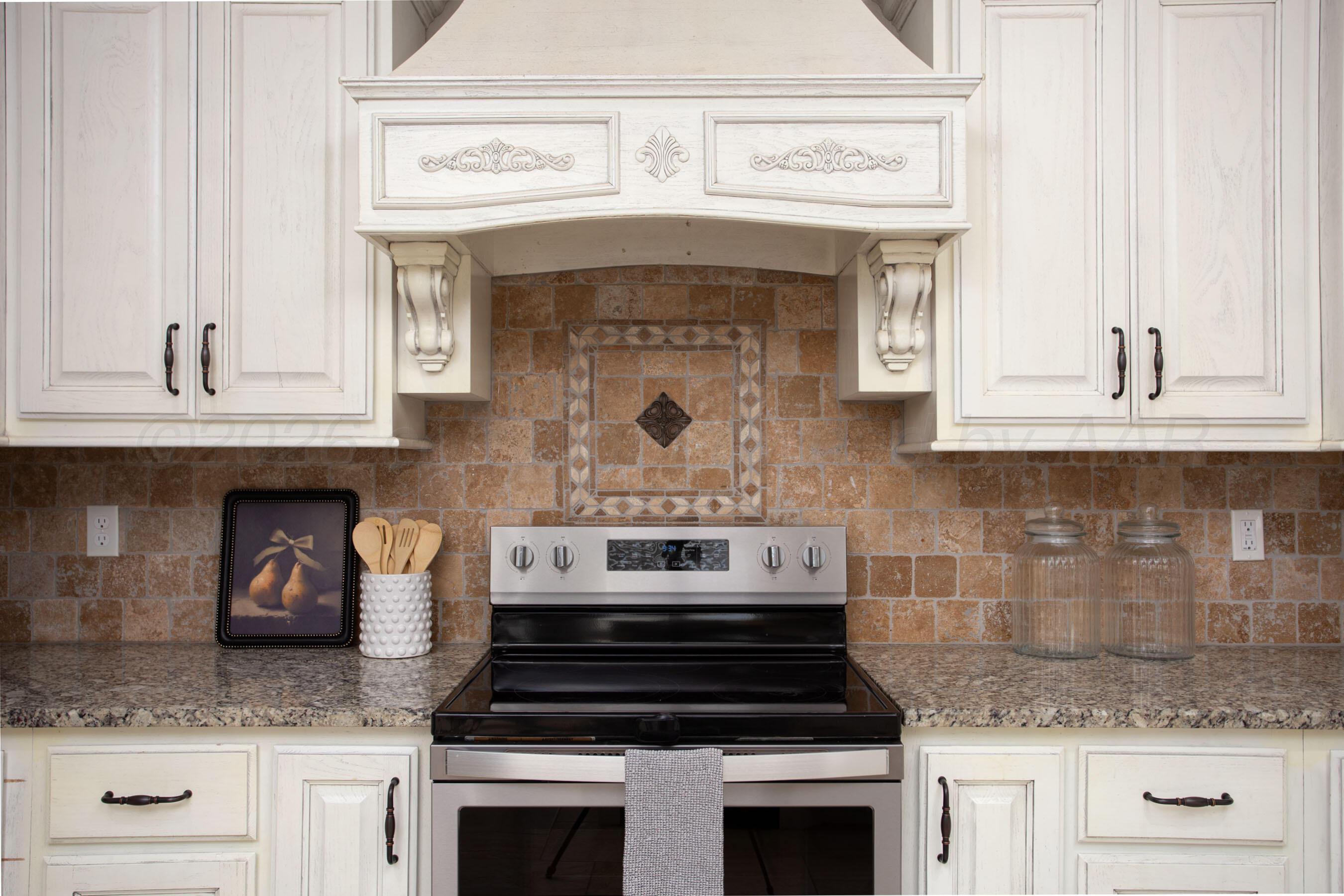 9551 Yesterday Lane Amarillo, TX 79119 - Photo 16 of 53 a kitchen with a stove and white cabinets