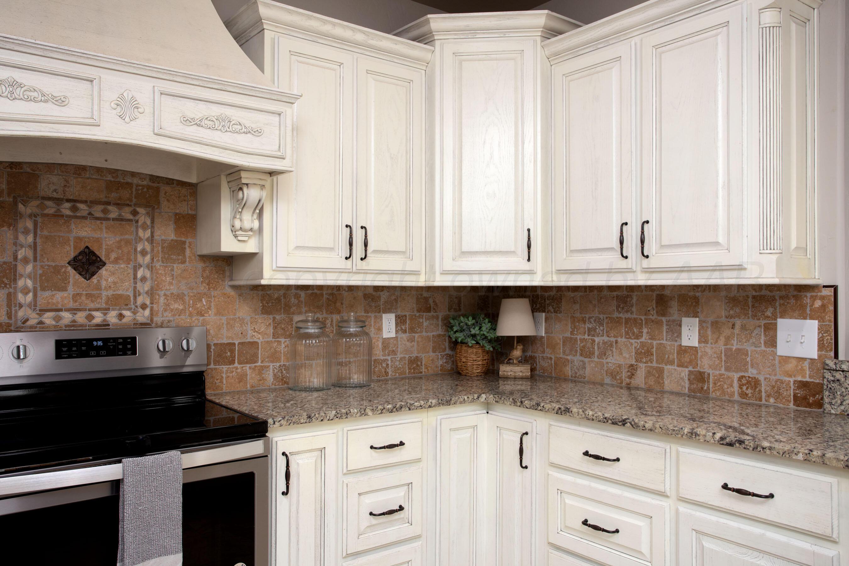 9551 Yesterday Lane Amarillo, TX 79119 - Photo 17 of 53 a kitchen with granite countertop white cabinets and white appliances