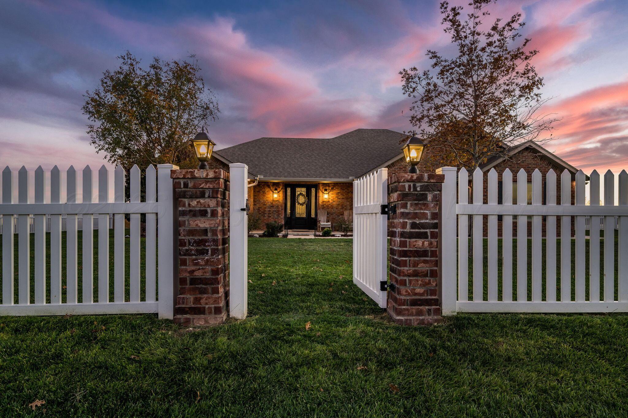 9551 Yesterday Lane Amarillo, TX 79119 - Photo 2 of 53 a front view of a house with a garden