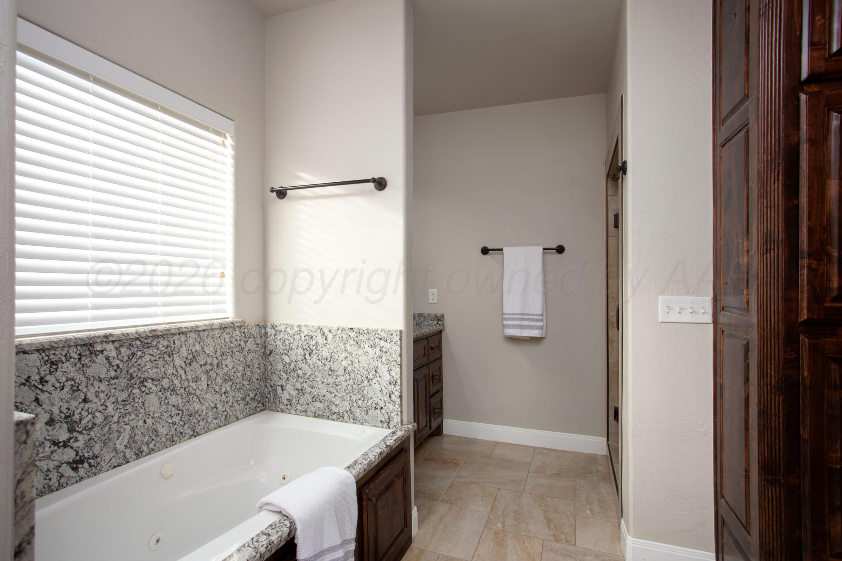 9551 Yesterday Lane Amarillo, TX 79119 - Photo 23 of 53 a bathroom with a bathtub and window