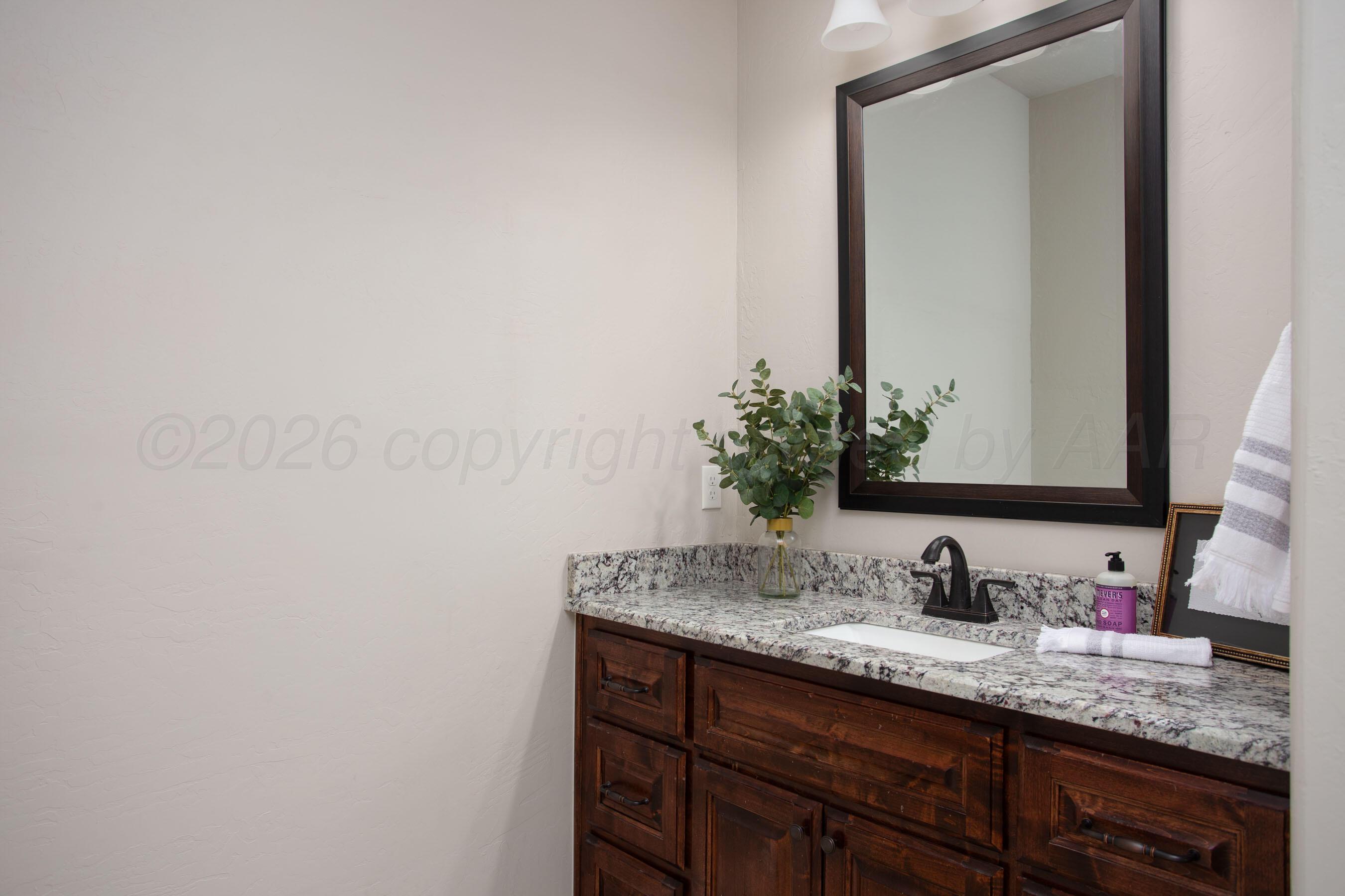 9551 Yesterday Lane Amarillo, TX 79119 - Photo 24 of 53 a bathroom with a granite countertop sink and a mirror