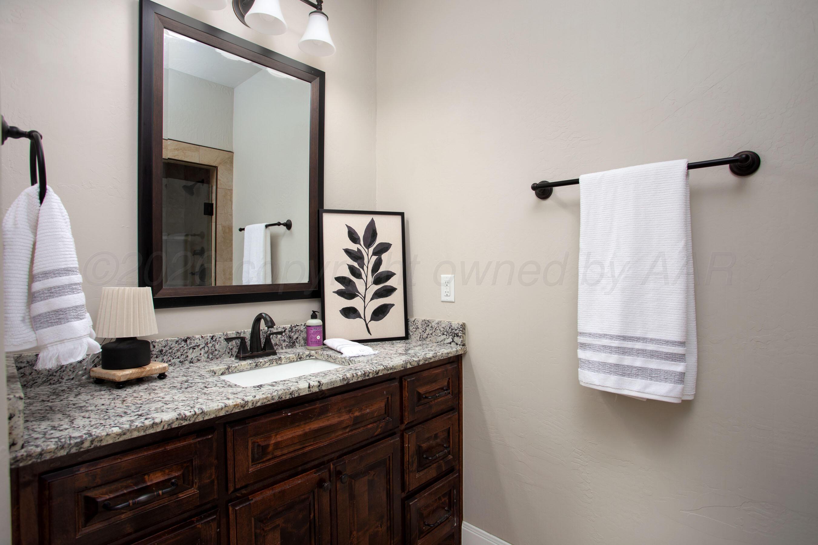 9551 Yesterday Lane Amarillo, TX 79119 - Photo 25 of 53 a bathroom with a granite countertop sink and a mirror