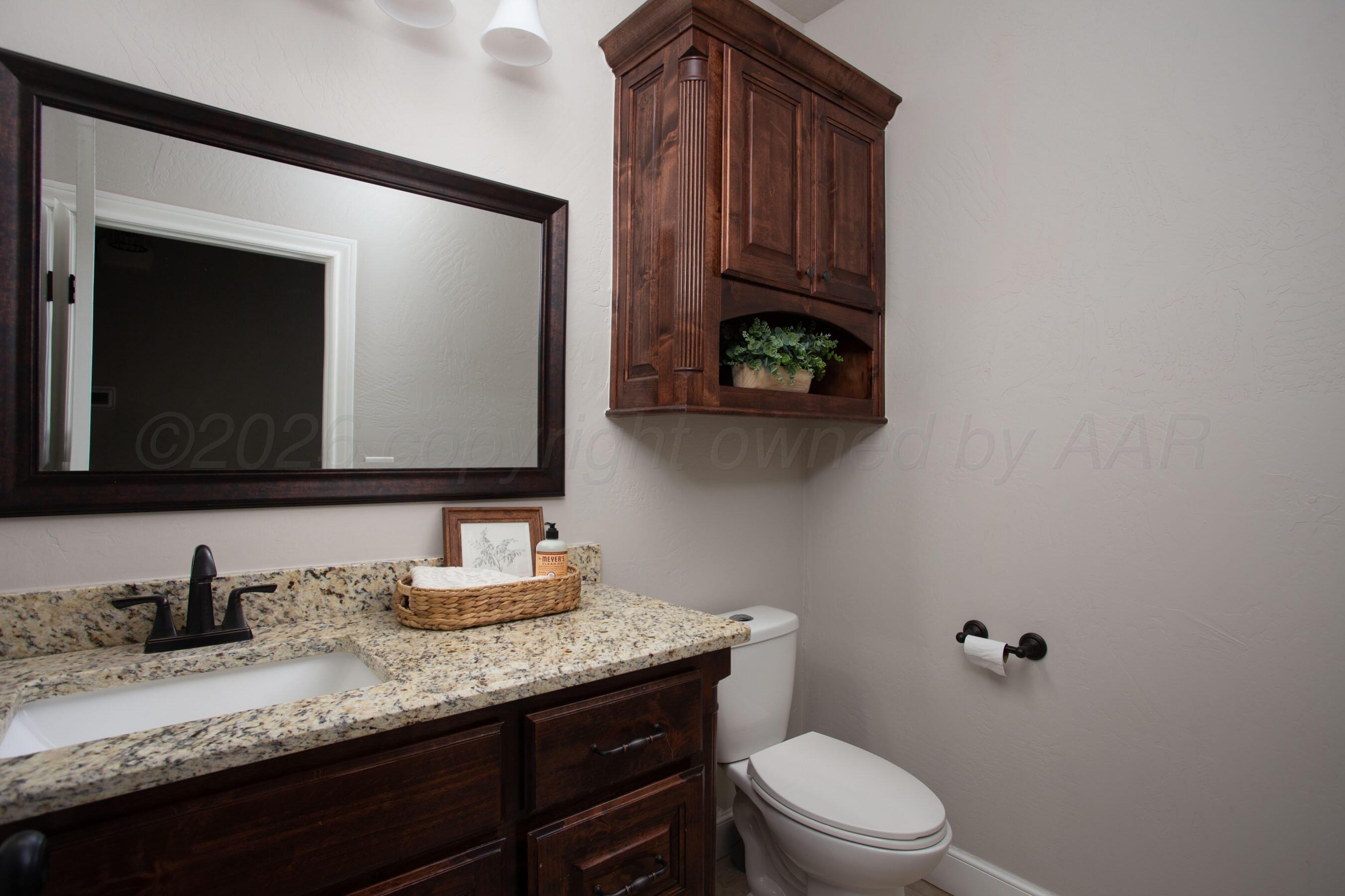 9551 Yesterday Lane Amarillo, TX 79119 - Photo 27 of 53 a bathroom with a granite countertop toilet sink and mirror