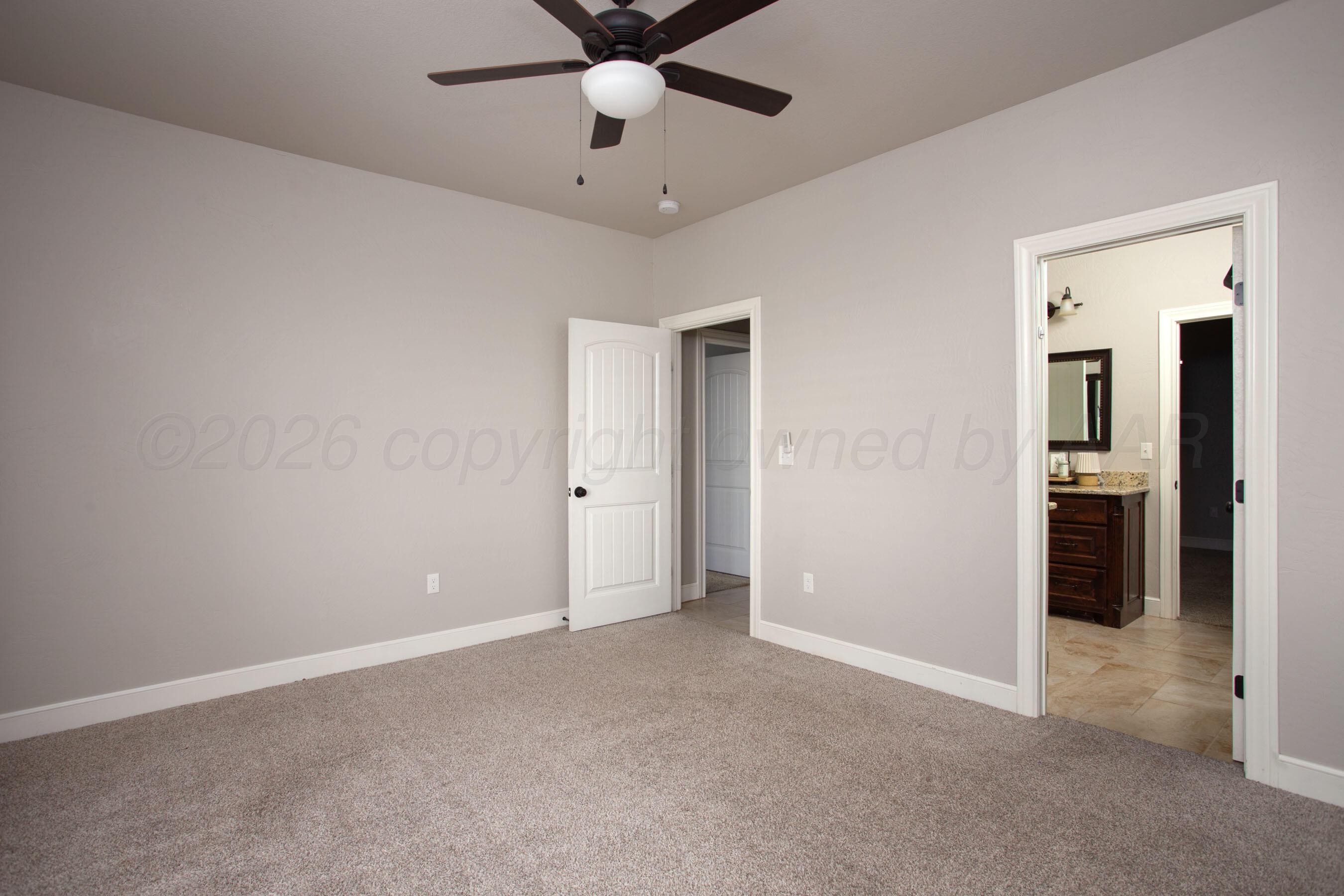 9551 Yesterday Lane Amarillo, TX 79119 - Photo 29 of 53 an empty room with closet and a ceiling fan
