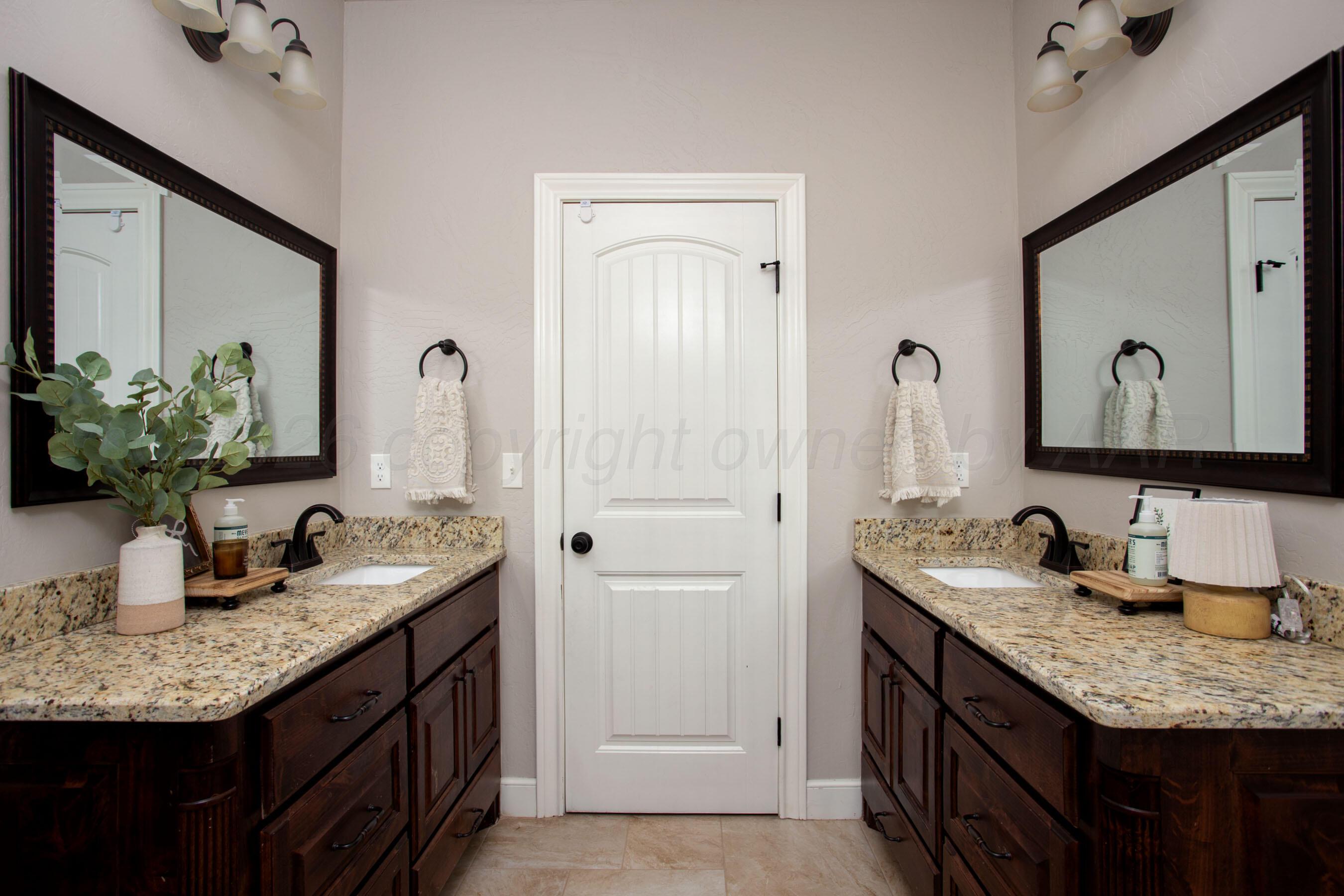 9551 Yesterday Lane Amarillo, TX 79119 - Photo 32 of 53 a bathroom with a granite countertop sink and a mirror