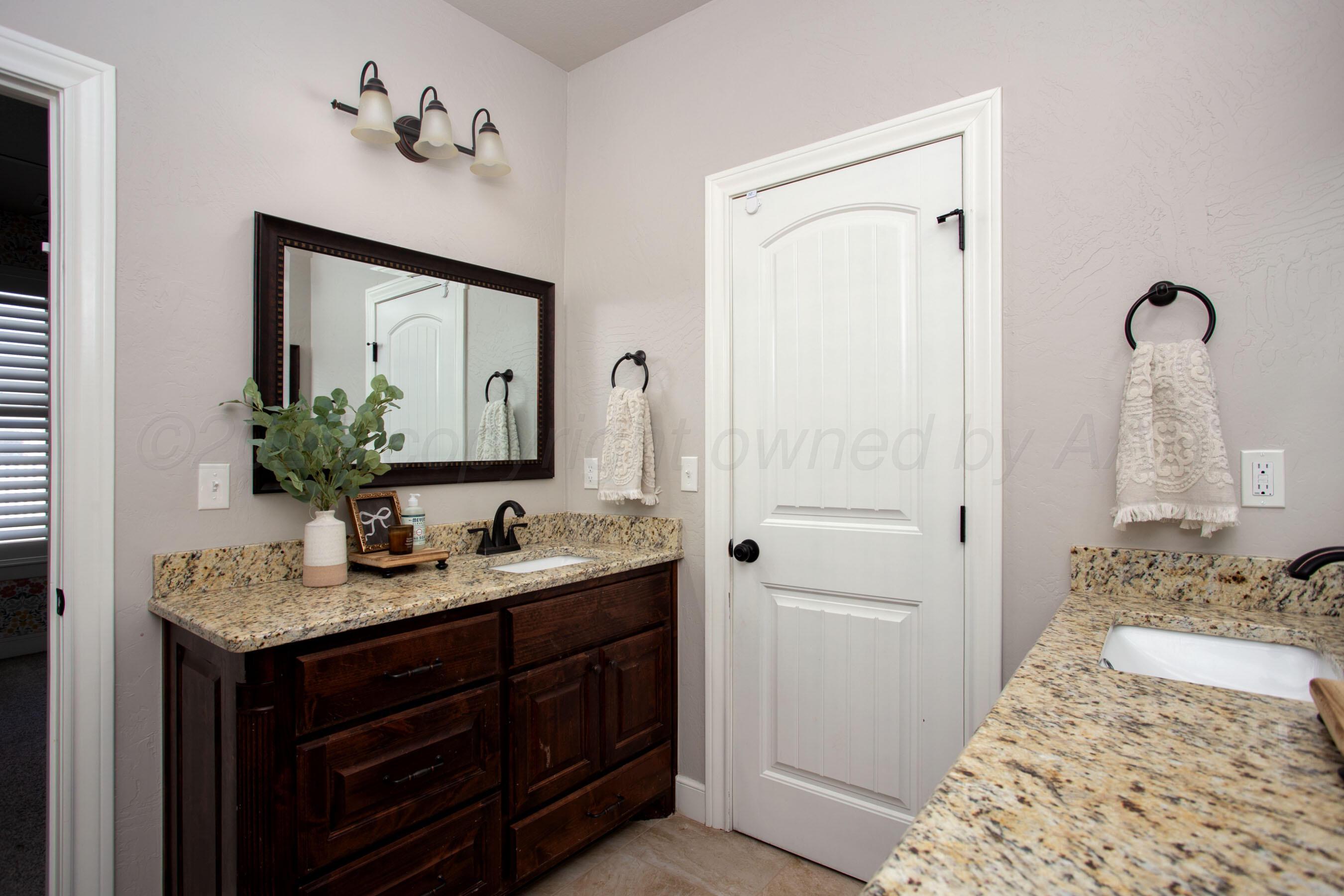 9551 Yesterday Lane Amarillo, TX 79119 - Photo 33 of 53 a bathroom with a granite countertop sink and a mirror